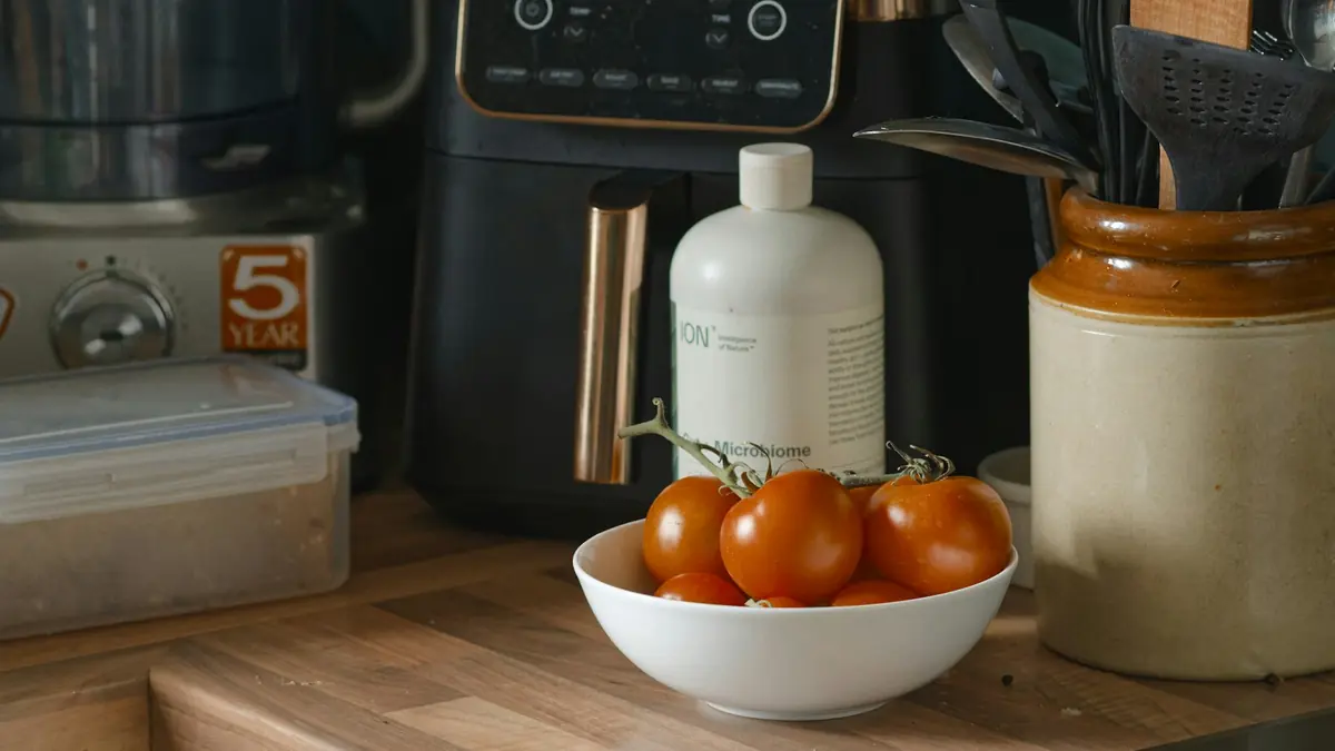 Tomatoes and kitchen appliances on a counter